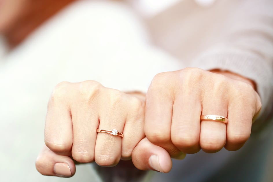 Couple Showing Hands with Engagement Rings